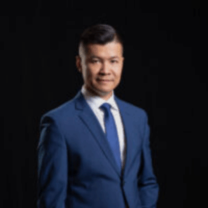 Thanh looking at the camera and smiling.