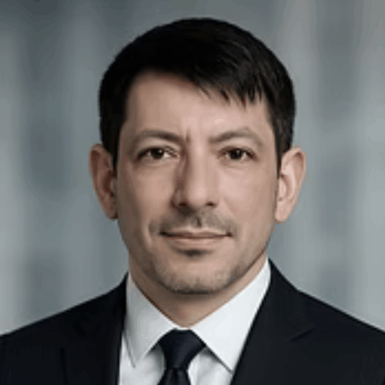 Erkan looking at the camera and smiling.