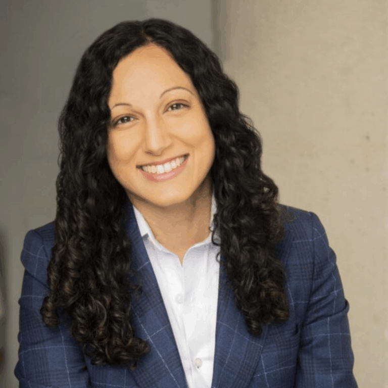 Khadija looking into the camera and smiling.