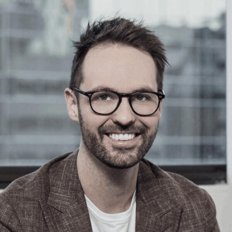 Nicolas looking into the camera and smiling.