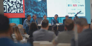 An audience sitting in front of a panel.