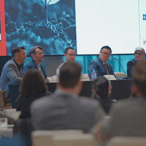 An audience sitting in front of a panel.